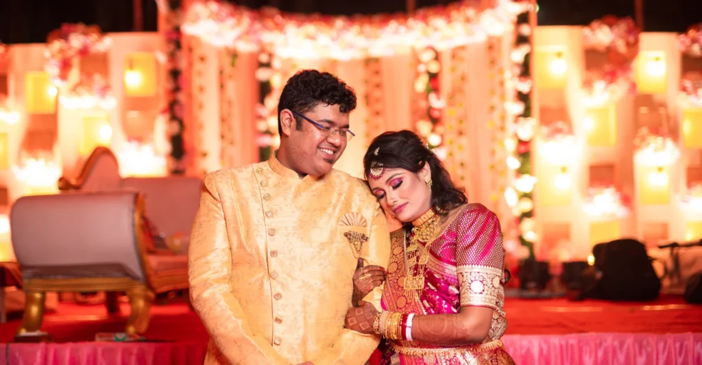 Romantic Bengali bride and groom portrait on decorated reception stage photographed by Golden Memories Kolkata wedding photographer